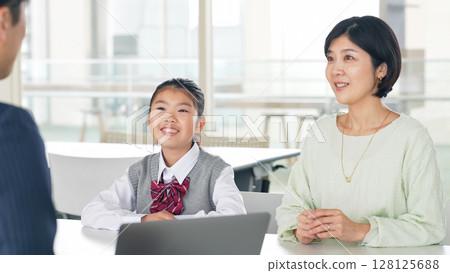 Parent and child having a three-way interview Parent and child having a three-way interview 128125688
