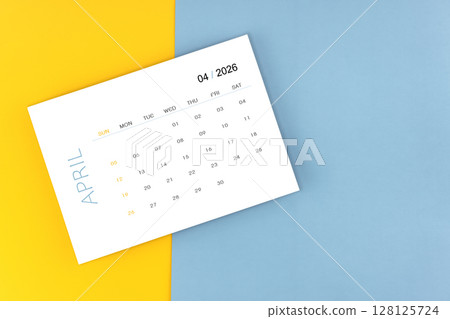 April 2026 calendar page on blue color background, Position with copy space. April 2026 calendar page on blue color background, Position with copy space. 128125724