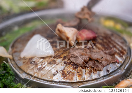 Thai style pork, bacon and seafood barbecue with vegetable soup Thai style pork, bacon and seafood barbecue with vegetable soup 128126164