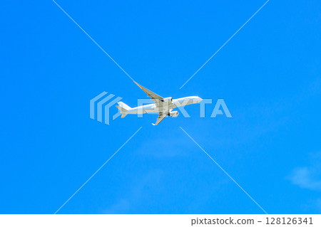 A jet plane flying in a beautiful blue sky, cropped 128126341