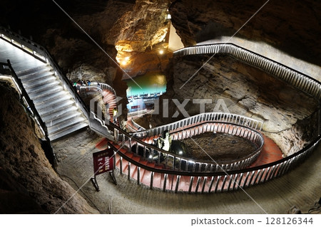 Zhangjiajie, Hunan Province, China - March 12, 2025: The beautiful interior of the Huanglong Cave in Zhangjiajie.ean landscapes within the cave. 128126344
