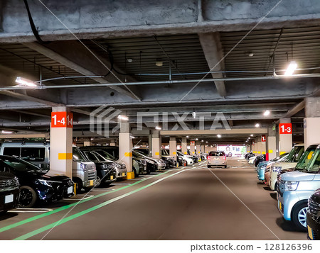 Cars parked in a multi-storey parking lot 128126396