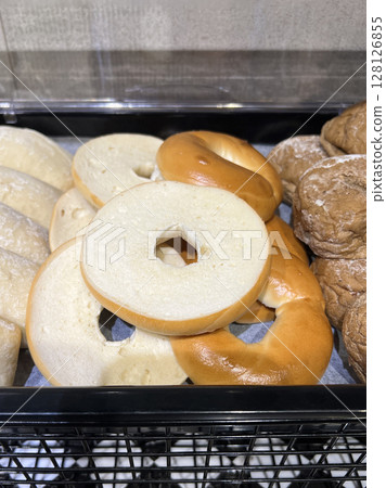 Photographing three different types of breakfast bread in a cafeteria 128126855