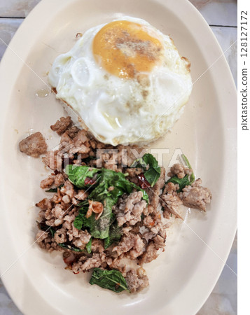 Top view of Stir fried Thai basil with minced pork and a fried egg, focus selective Top view of Stir fried Thai basil with minced pork and a fried egg, focus selective 128127172
