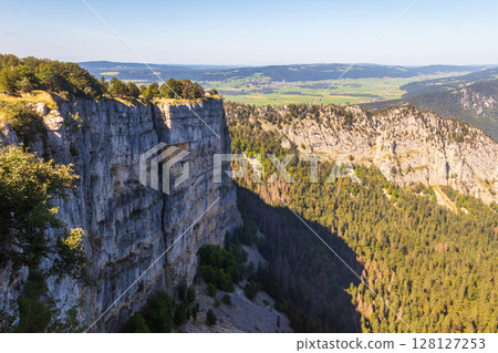 View of Creux Du Van, the amphitheater shaped rock formation, which is 1400 metres wide and 150 metres deep, in Neuchatel canton, Switzerland 128127253
