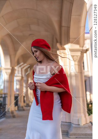 Beret Shawl Dress: Woman poses under arches in daytime for photoshoot outdoors. 128127349