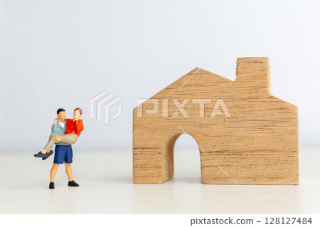 Miniature Couple Moving into New Home Together Miniature Couple Moving into New Home Together 128127484
