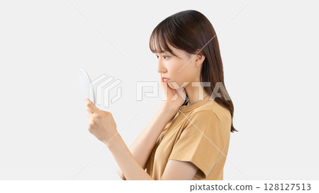 A young woman suffering from skin problems A young woman suffering from skin problems 128127513