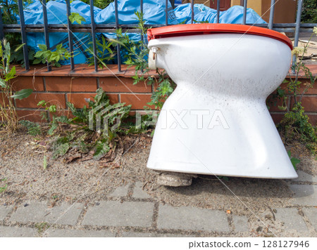 Old dirty toilet bowl on sidewalk 128127946