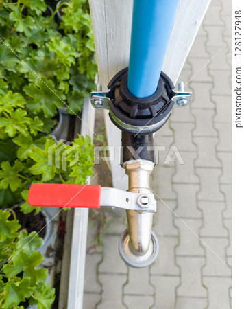 Outdoor water valve with red handle 128127948