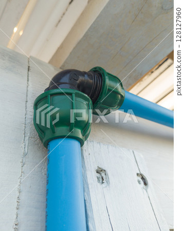 Water pipe elbow joint connection close up 128127960