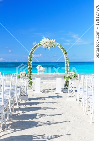 Tropical paradise  wedding setting and beautiful wedding arch on the beach 128127976