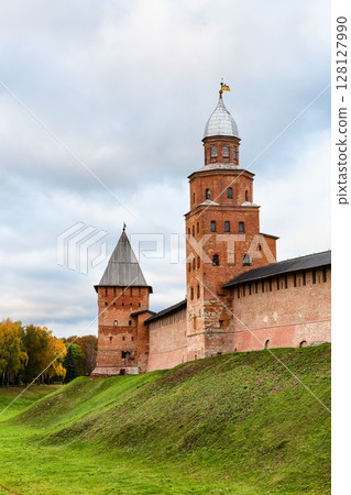 Autumn landscape with Novgorod Kremlin is fortress in Veliky Novgorod, Russia. Veliky Novgorod Kremlin in autumn day with dramatic cloudy sky. Autumn landscape with Novgorod Kremlin is fortress in Veliky Novgorod, Russia. Veliky Novgorod Kremlin in autumn day with dramatic cloudy sky. 128127990