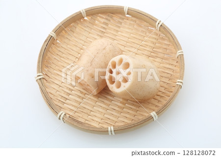 Aerial view of lotus root cross section on bamboo basket 128128072