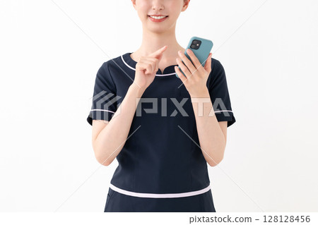 Woman pointing at smartphone 128128456