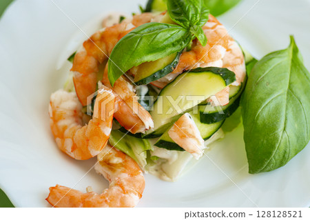 Culinary serving of salad with shrimps on a wooden table Culinary serving of salad with shrimps on a wooden table 128128521