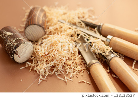 Wood carving close-up with sawdust 128128527