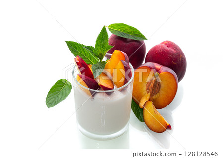 Sweet yogurt and juicy nectarines with red skin on white 128128546