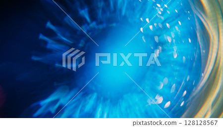 Shiny ray. Bokeh circle. Defocused blue yellow colorful radiant golden fluorescent lens flare moving on abstract neon blurred background. Shiny ray. Bokeh circle. Defocused blue yellow colorful radiant golden fluorescent lens flare moving on abstract neon blurred background. 128128567