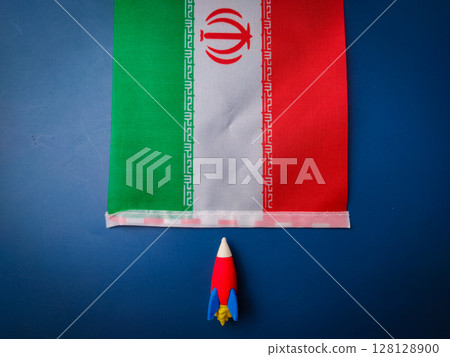 Toy rocket and iran flag on a blue background.Geopolitics concept. 128128900