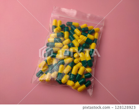 Closeup of a medicine pill package on a pink background. 128128923