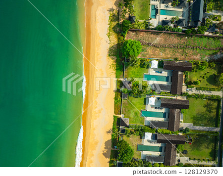 Ocean waves crashing on rocks as seen from an aerial perspective Ocean waves crashing on rocks as seen from an aerial perspective 128129370