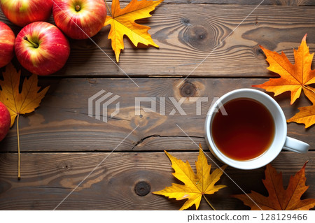 Apples and tea on a wooden table. 128129466