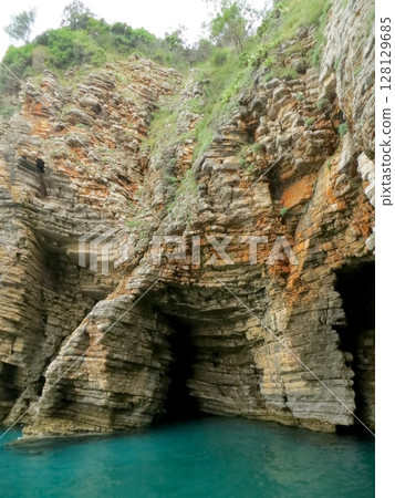 Exploring Stunning Rock Formations of Sveti Nikola Island in Montenegro on a Bright Sunny Day 128129685