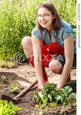 woman gardener replanting flowers 128130108