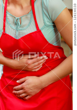 Woman suffering from stomach ache abdominal pain. Woman suffering from stomach ache abdominal pain. 128130110