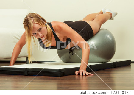 woman doing fitness exercises with fit ball woman doing fitness exercises with fit ball 128130181