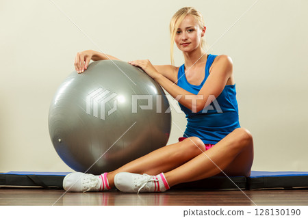 woman doing fitness exercises with fit ball woman doing fitness exercises with fit ball 128130190