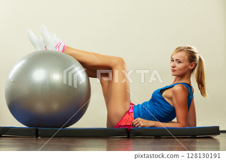 woman doing fitness exercises with fit ball 128130191