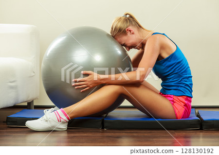 woman doing fitness exercises with fit ball 128130192