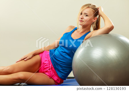 woman doing fitness exercises with fit ball 128130193