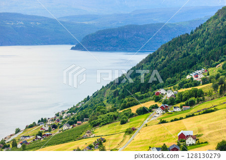 Norwegian country houses in the mountains on lake shore Norwegian country houses in the mountains on lake shore 128130279