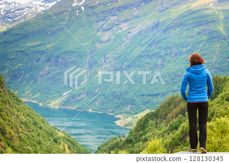 Woman tourist in norwegian mountains fjords Woman tourist in norwegian mountains fjords 128130345