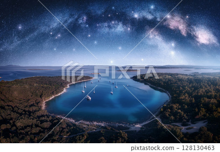 Milky Way arch and aerial view of yachts and boats on the sea 128130463