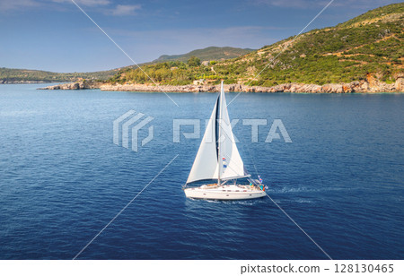 Aerial view of beautiful sail boat. Boat on the sea at sunset Aerial view of beautiful sail boat. Boat on the sea at sunset 128130465