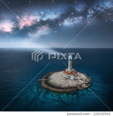 Lighthouse on smal island in the sea and Milky Way at night 128130503