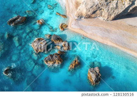 Aerial view of blue sea, rocks in clear water, white sandy beach Aerial view of blue sea, rocks in clear water, white sandy beach 128130516