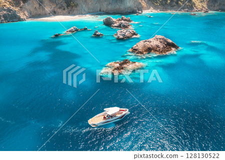 Speed boat in blue sea at sunrise in summer. Aerial view 128130522
