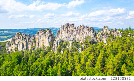Dry rocks, Czech: Suche skaly, rise majestically in Bohemian Paradise. Surrounded by lush forests, these sandstone formations offer stunning views and unique geological features to explore. Dry rocks, Czech: Suche skaly, rise majestically in Bohemian Paradise. Surrounded by lush forests, these sandstone formations offer stunning views and unique geological features to explore. 128130581
