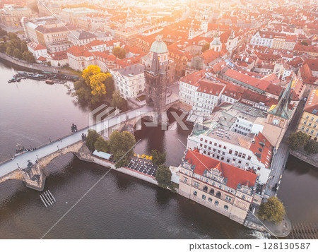 Overlooking the Vltava River, Charles Bridge connects Old Town with Mala Strana, highlighted by the Old Town Bridge Tower. The stunning architecture defines Prague's historic skyline. 128130587