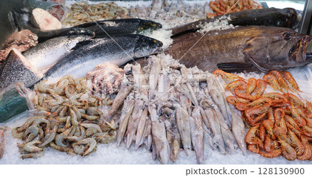 Colorful display of fresh seafood at fish market in Greece. Customers can find various fishes and marine delicacies on ice, ready for purchase and enjoyment. 128130900