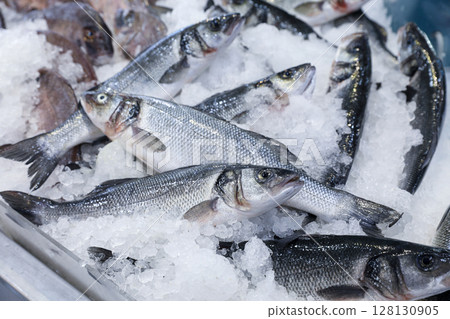 Fresh European seabass or Dicentrarchus labrax, lavpaki on ice in Greek fish market during morning hours. Fresh European seabass or Dicentrarchus labrax, lavpaki on ice in Greek fish market during morning hours. 128130905