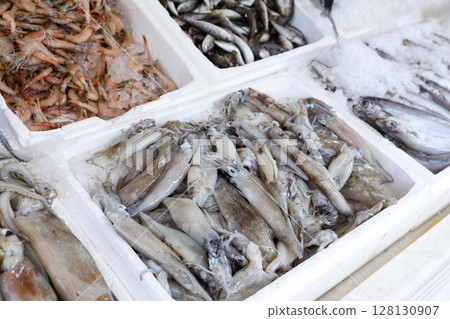 Colorful assortment of fresh seafood displays in Greek fish market. Ice surrounds various fish types, creating an inviting atmosphere for shoppers. 128130907