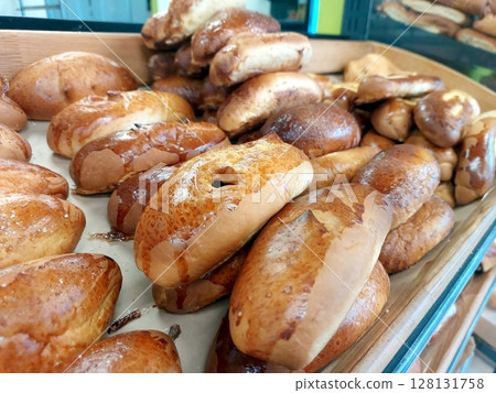 Freshly Baked Rolls Displayed in a Bakery at Midday 128131758