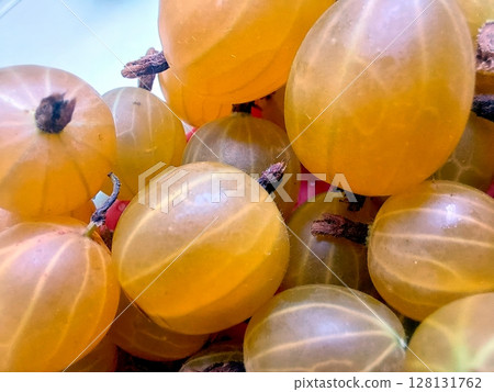 Gooseberry Berries in Vibrant Yellow Hues Displayed in a Sunny Market Setting Gooseberry Berries in Vibrant Yellow Hues Displayed in a Sunny Market Setting 128131762
