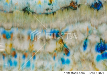 abstract pattern on silk fabric texture in blue, yellow, green colors 128131821